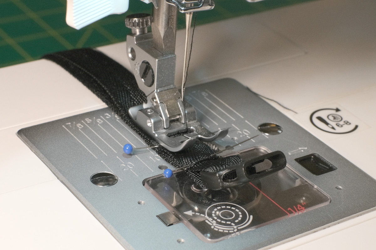 Putting the strap in the sewing machine with the pins still in, oriented long-ways